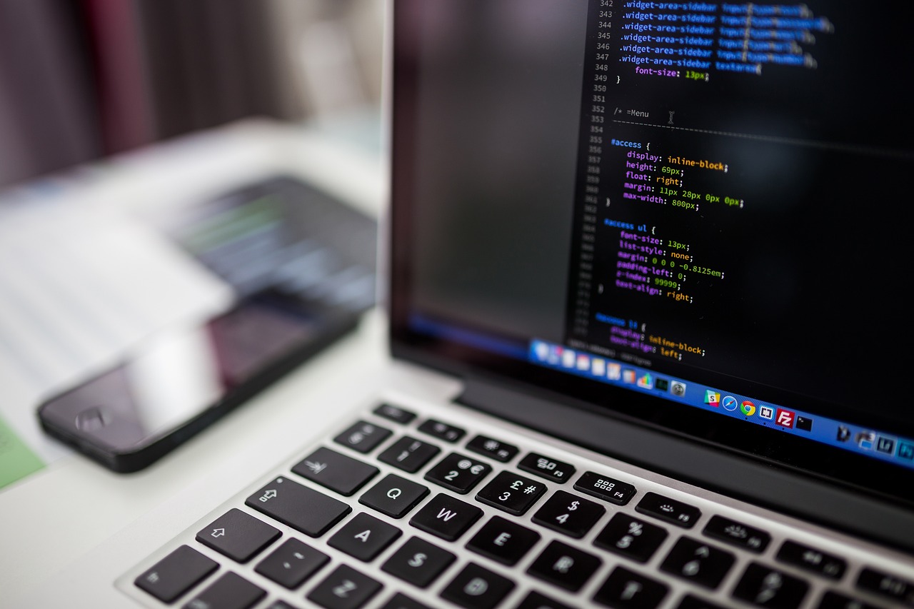 Developer working on website code at a laptop